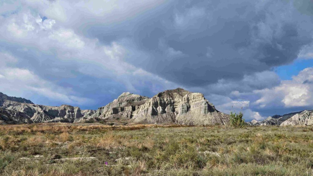Storm clouds gathering over eroded badland peaks in Vashlovani, Georgia