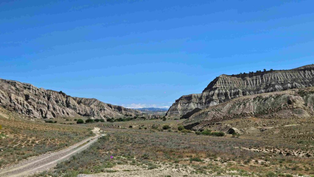 Dirt road through a canyon flanked by badland walls, Vashlovani, Georgia