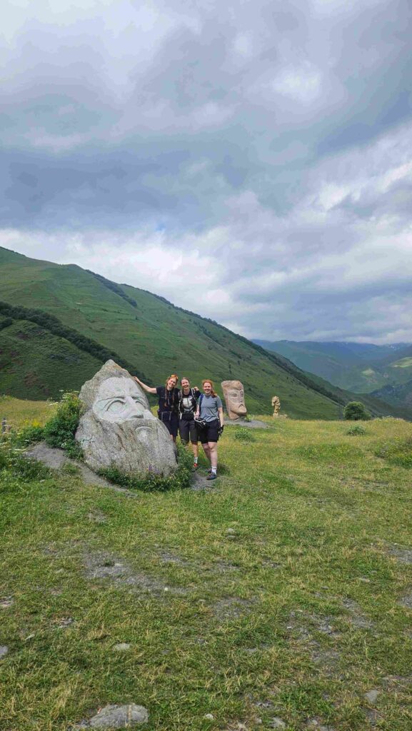 Taking a rest break on the grassy mountain slopes during a Juta Valley MTB tour, Georgia