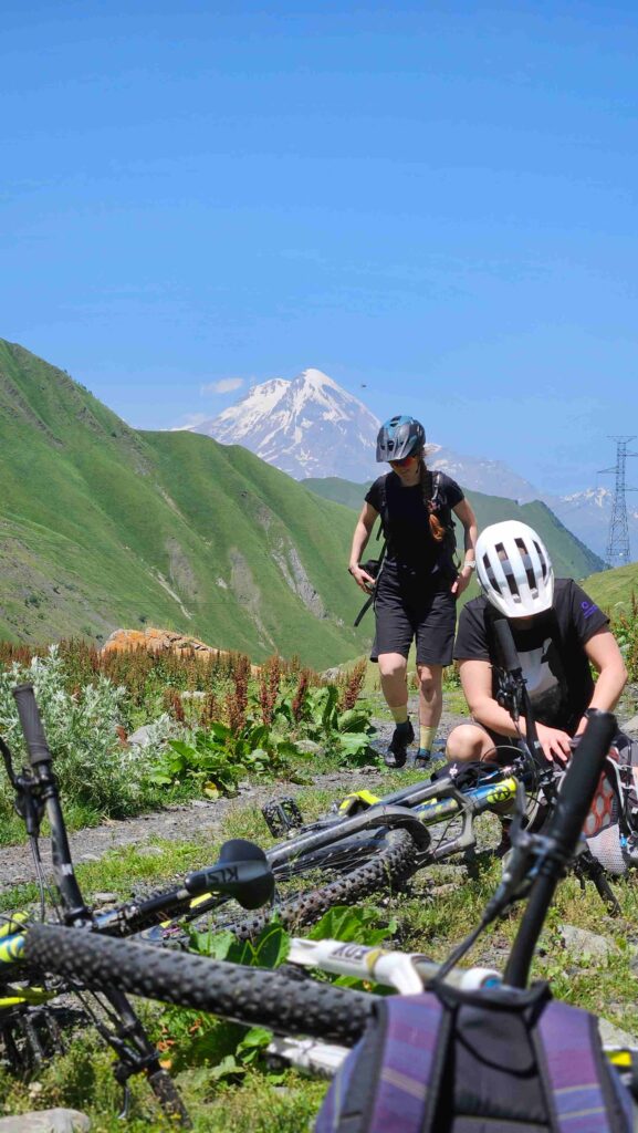 MTB group navigating a river crossing on the Gudamakari Valley route, Georgia